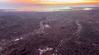 Cloudy sunset downtown San Diego with an airplane landing