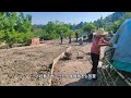 digging machine to repair rural cement road villagers sit beside onlookers roadbed hard digging m