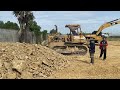 incredible komats u bulldozer pushing and big dump truck unloading soil into water