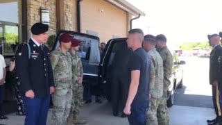 The casket of Army Spc. Luis Herrera arrives at Beam Funeral Home