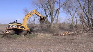 CAT 345 BL Series II Excavator taking out trees