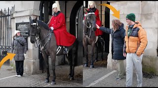 The guard reprimands them, ordering them to stay behind the white line and not touch the horse.