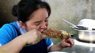 Sister Miao eats steak with one in her left hand and one in her right.