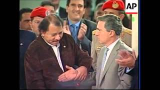 Colombia President Uribe shakes hands with Chavez, Correa