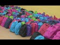 Volunteers hand out over 1,000 backpacks full of school supplies to CPS students