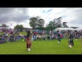 drum major leads the massed pipes and drums march in during 2024 dufftown highland games in scotland