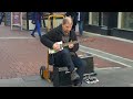 brian lea playing a recycled oil can guitar