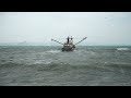 fishing boats entering and exiting newlyn harbour in rough seas cornwall commercial fishing