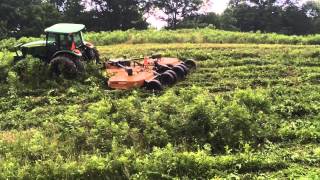 John Deere 5100M mowing steep hill