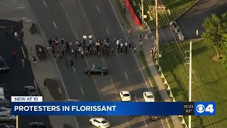 Protesters call for the firing of Florissant police officer who hit unarmed man with patrol car