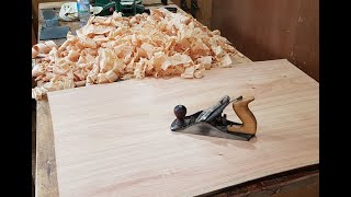 Flattening a wooden slab with hand planes for a coffee table