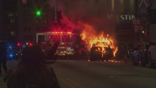 Police vehicle burning during Atlanta 'Cop City' protest