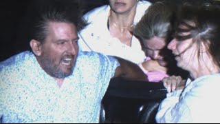 Adults Hold On To Girl In Danger Of Being Swept Out Of Roller Coaster
