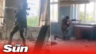 Ukrainian soldiers launch rockets from inside a building on the Sieverodonetsk front line