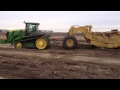 Loading a 24 yd scraper with Deere 9560RT Pt 1