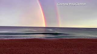 Double rainbow seen over horizon in Australia