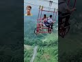 A couple ride an aeiral bicycle and the woman is the little scared #travel #adventure #fun #zipline