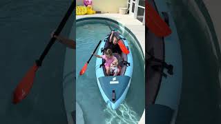 Children are exploring the pool in a kayak