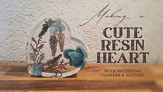 Making a cute resin heart with artificial flowers and glitter