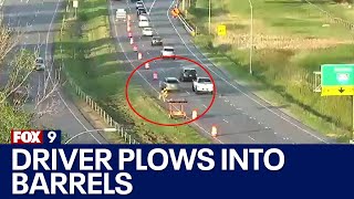 Driver plows into construction barrels, sending one into worker