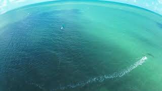 Emerald Escape: Kiteboarding Flying Above Emerald Waters