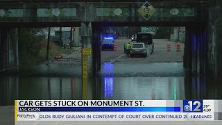 Car gets stuck in flooding on Monument Street in Jackson