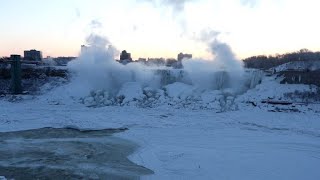 Images of a frozen Niagara Falls at sunrise