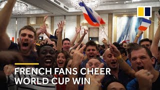 French soccer fans celebrate their team’s World Cup victory in Hong Kong