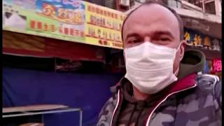 A man walking through virus-stricken Wuhan shows empty streets and what he calls 'fake people'