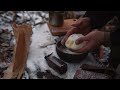 winter survival camping in heavy snowfall of 15°c meat on a wooden grill