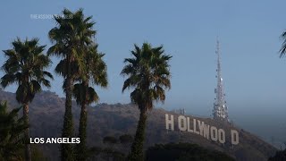 Locals check the Hollywood sign after seeing false reports of the iconic landmark burning