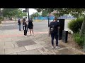 young people queue outside greenwich pharmacy for covid vaccine