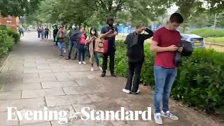 Young people queue outside Greenwich pharmacy for Covid vaccine