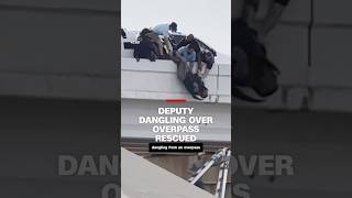 Deputy dangling over overpass rescued