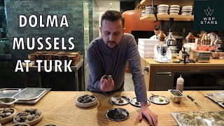 Chef Fatih Tutak prepares a dish with DOLMA MUSSELS at restaurant TURK in Istanbul, Turkey