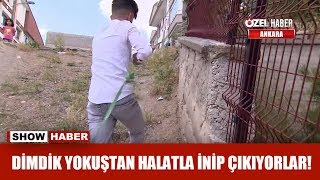 Dimdik yokuştan halatla inip çıkıyorlar!