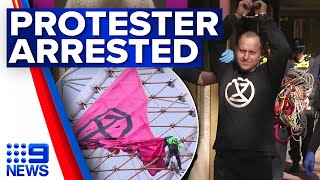 Climate protester arrested after climbing Arts Centre Melbourne spire | 9 News Australia