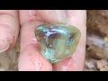 diamonds and emeralds emerge from crevices in rocks after torrential rain