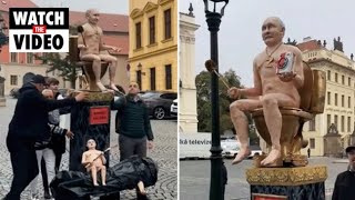 Demonstrators carry statue of naked Putin and Lukashenko to Prague summit