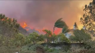 Brush fire in the Pacific Palisades neighborhood of Los Angeles destroys homes and forces thousands