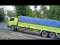 dozens of trailers crossing a narrow bend on the road