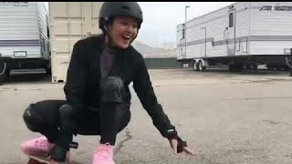 Chelsea t zhang playing skateboard​ on set Daybreak #6