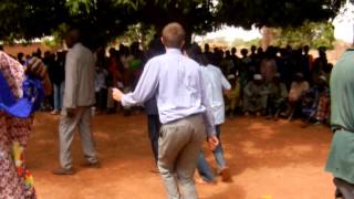 Mali President candidate Yeah Samake watches American friends dance