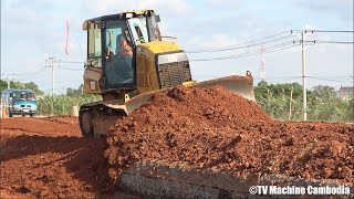 Caterpillar D5K dozer spreading red dirt អាប៊ុលរុញដីក្រហមធ្វើផ្លូវ