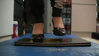 S01E06 - High heels, crushing gummy bear candies, on top of a laptop, on top of a squishy mat.