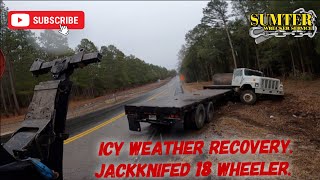 Icy weather recovery. Jackknifed 18 wheeler.