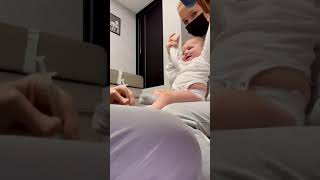 Doctor entertains baby while giving her a shot and she does not flinch