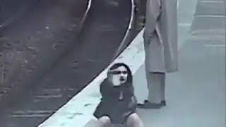 Beautiful girl painting penis on man's jacket in publicrailway station. Caught on camera