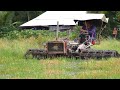 Homemade tractor shoveling wetlands