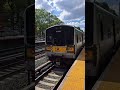 2 M7 LIRR train one enters and depart one bypassing Kew Gardens